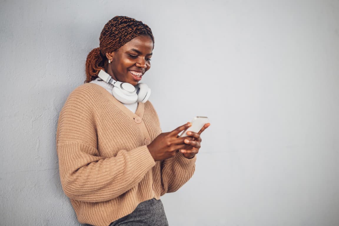 Woman with headphones using her phone