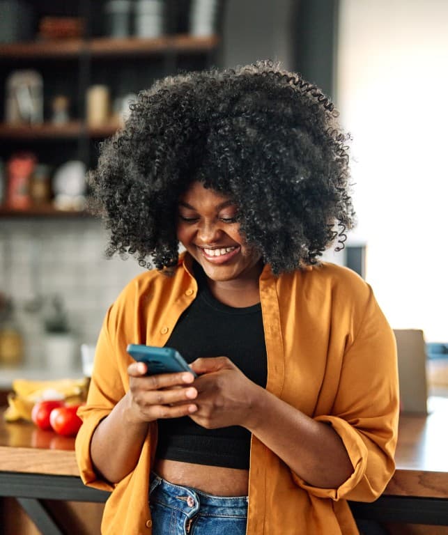 Woman using Airkobo on her phone in her kitchen